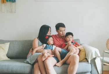 a happy family sitting on a sofa