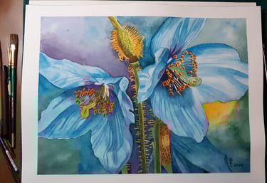 a watercolor painting of a blue hyacinth on a table with paintbrushes next to the painting