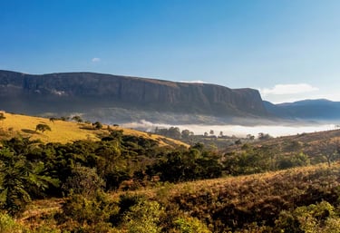 a mountain view of a valley with a valley in the background