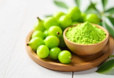 Dewy green Amla fruits placed beside a bowl of light green powder on a clean wooden surface, illumin