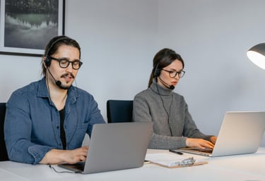 two people one male and one female are looking to the computers while setting looks like working.