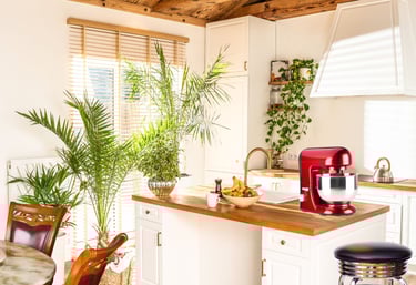 a kitchen with a red mixer and a table with a table and chairs