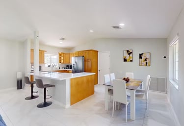 a kitchen with a table and chairs and a table