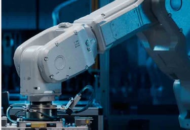 A robotic arm in a food packaging facility, positioned over a conveyor belt.