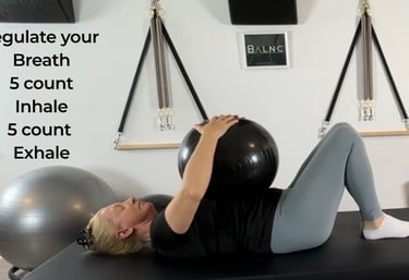 a woman showing individuals how to work with a ball therapeutically