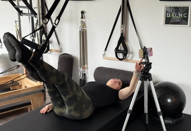woman working from the app in a Pilates studio