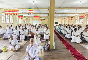 a group of people sitting in a room with many people
