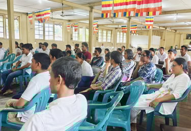 a group of people sitting in chairs in a room for meditation