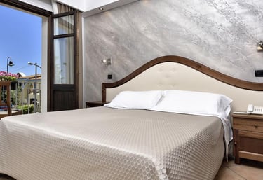 a bed room with a bed and a balcony