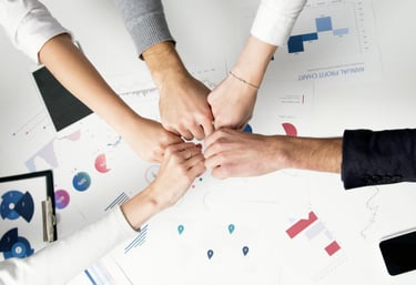 a group of people holding hands in a circle