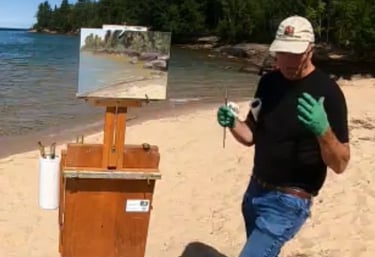 Gary McCaslin giving instructions on painting methods while on location at the beach