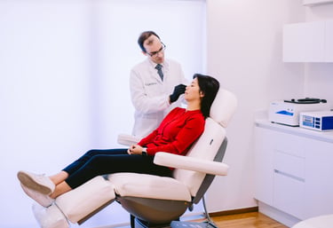 Dr Matthaios Souchlakis assessing a patient during consultation at Athenaeum Aesthetics