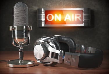 Picture of a mic headphones and a lit up 'on air' sign