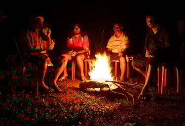 a group of people sitting around a campfire in Kattegadde Homestay - chikmagalur
