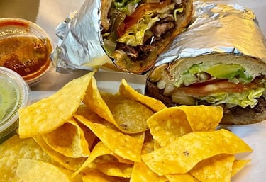 a Torta sandwich with chips and salsa on a plate
