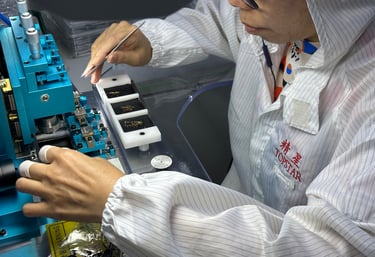 a woman in a white shirt and glasses crafting on a dial machine
