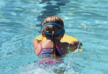 young child learning to swim