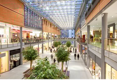 Shopping mall with bright indoor space and shops, illustrating high-traffic monitoring and surveillance