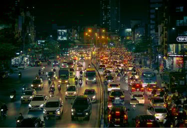 Night view of congested urban traffic with cars and motorcycles under city lights for congestion monitoring.