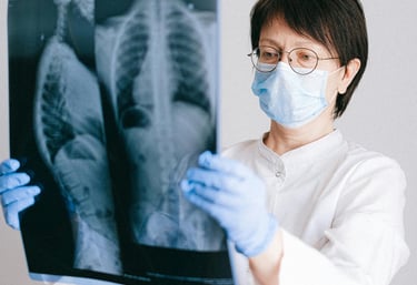 health insurance - a doctor observing a x ray report of a patient