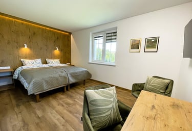 a guest room with king size double bed and desk area