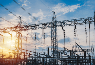 A picture of industrial power lines with a beautiful sunset in central texas