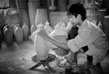 A young boy in Vietnam employed in jar-making through the lens of Peter Pickering