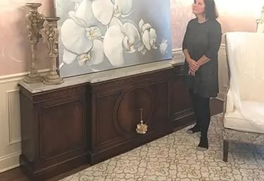 marcine standing next to orchid painting in pennington nj