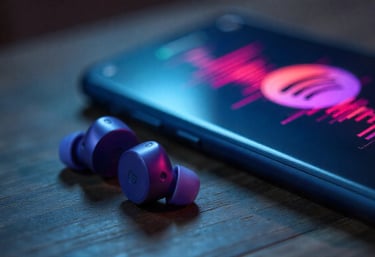 a cell phone with earphones and earphones on a table