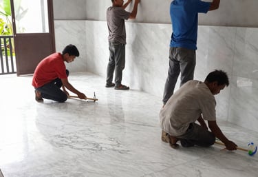 Construction workers collaborating on a residential building site with blueprints and tools.