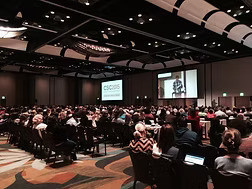 A photo of Hank Smith speaking during a This Autistic Life presentation.
