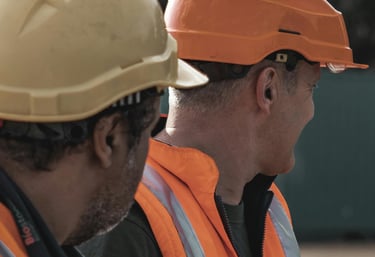 two men in orange safety vests and safety vests