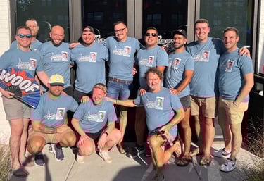 a group of people standing in front of a building wearing matching tshirts