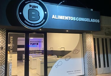 a business sign on a building with a phone in front of it