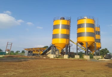 a concrete batching planter with two large yellow and black cement batching