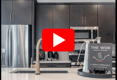a kitchen with a black and white kitchen with a black and white sign
