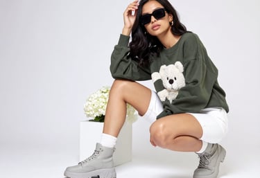 a woman in a green sweater and white sneakers