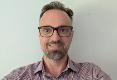 a handsome man with glasses and a beard