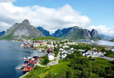 Aerial view of a scenic fishing village in Lofoten Norway with colorful houses and rugged mountains.