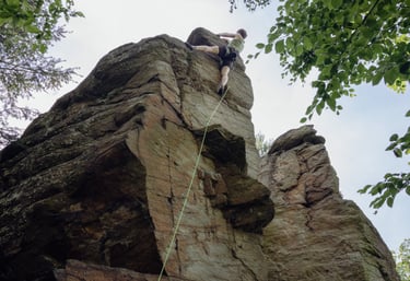 Climbing instructor Christoph lead climbs on the rock in Lower Austria