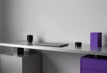 A minimalist and high-end workspace in a North American / US creative studio, featuring soft silver surfaces and royal purple decor details.