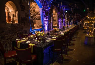 Event venue decorated with tall candles and Harry Potter theme – magical event photography by Fred A