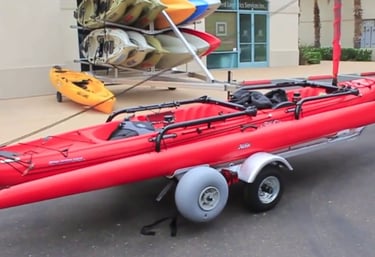 a red kayak on a trailer