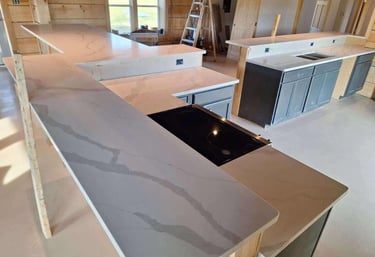Stone countertops installed in open-concept kitchen and living area