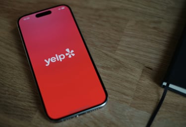 a picture of a cell phone with the Yelp app.