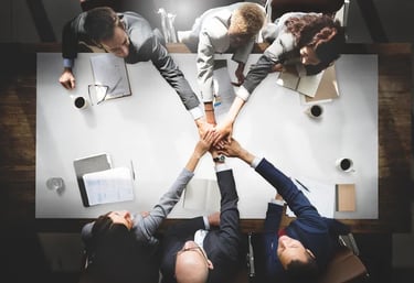 a group of people holding hands in a circle martin pe coach