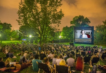 a large screen screen with people watching a movie