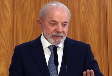 a man in a suit and tie is speaking into a microphone