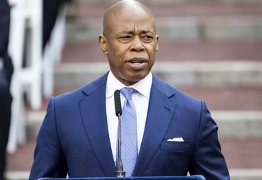 a man in a suit and tie standing in front of a podium