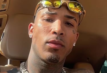 a man with sunglasses and sunglasses on his head